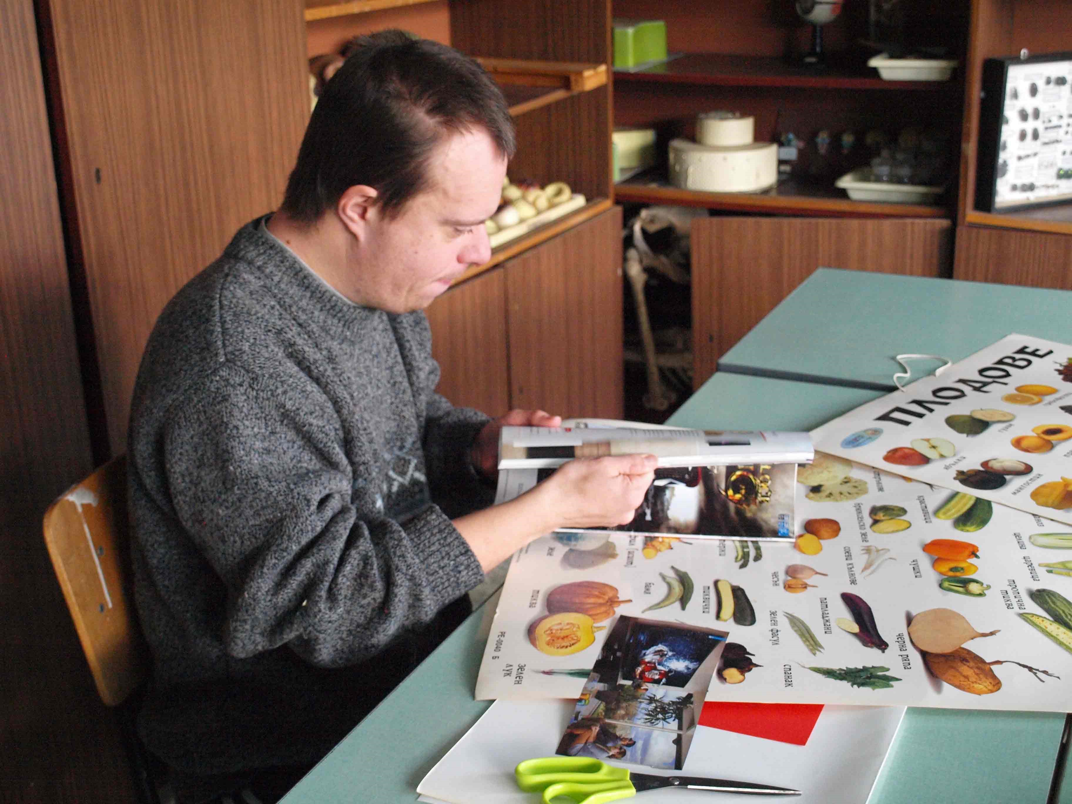 A student looking at a magazinee.