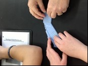 Two students with hands on a 3D printed model of the San Andreas fault in California.