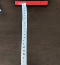 A thin strip of paper with letters taped to a red rod.