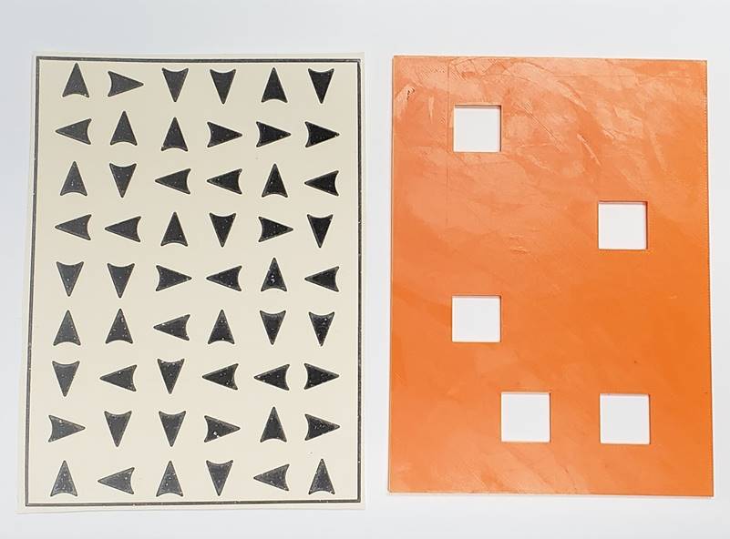 Two sheets, one with 9 rows of 6 arrows pointing towards different directions, the other an orange sheet with 5 square holes in different positions.